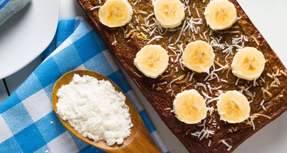 Banana protein bread topped with banana slices and shredded coconut.