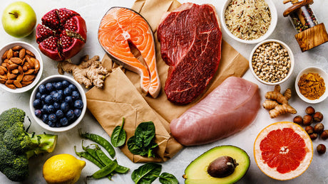 Healthy food assortment including salmon, beef, fruits, and vegetables.