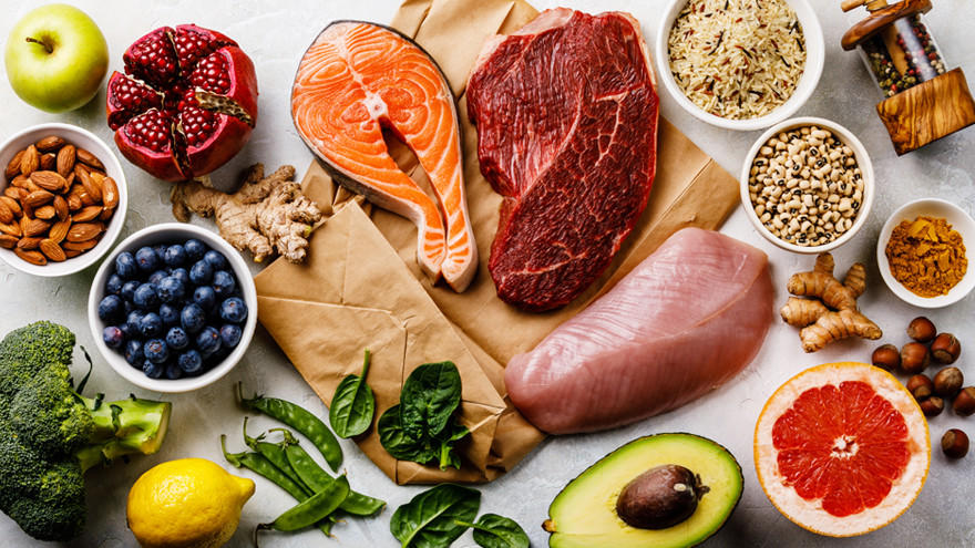 Healthy food assortment including salmon, beef, fruits, and vegetables.