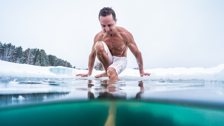 Man entering icy water during cold exposure therapy.