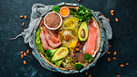 Healthy fats and protein sources arranged in rustic basket.