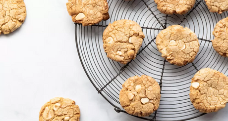 White chocolate chip cookies on a cooling rack.