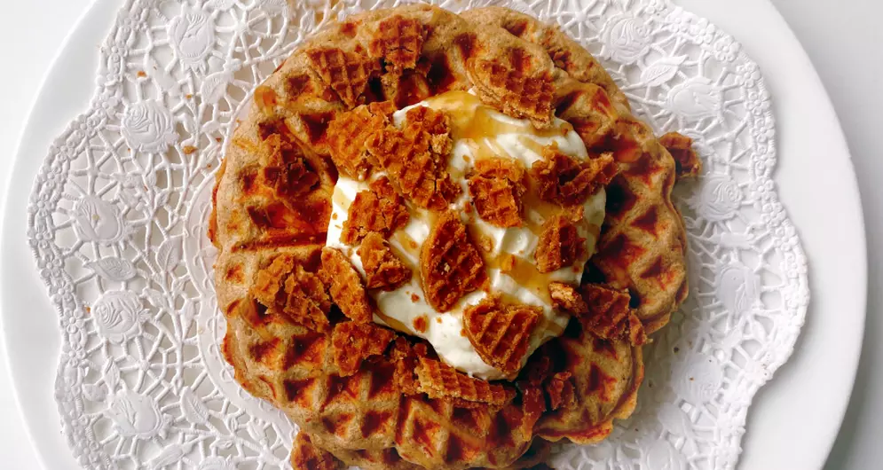 Protein waffle topped with cream and crushed stroopwafel.