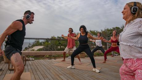 Group doing outdoor fitness with silent disco headphones.