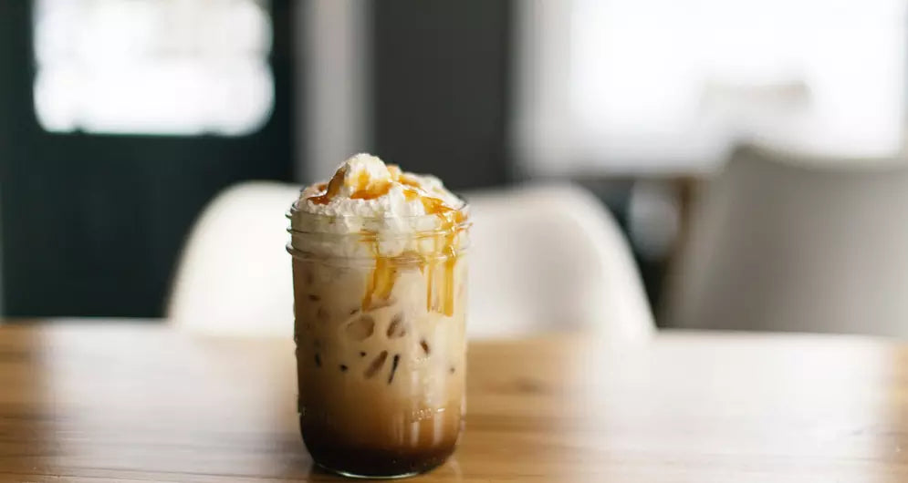 Iced caramel protein coffee in glass jar.