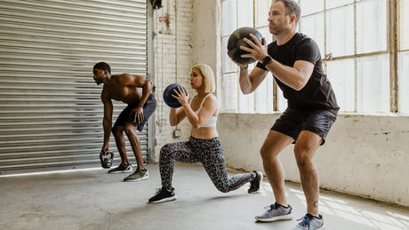 Group fitness training with medicine balls.
