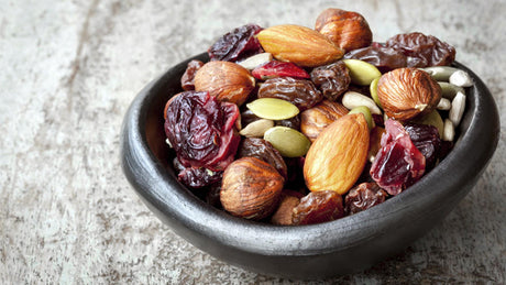 Bowl of assorted nuts, seeds, and dried fruit.
