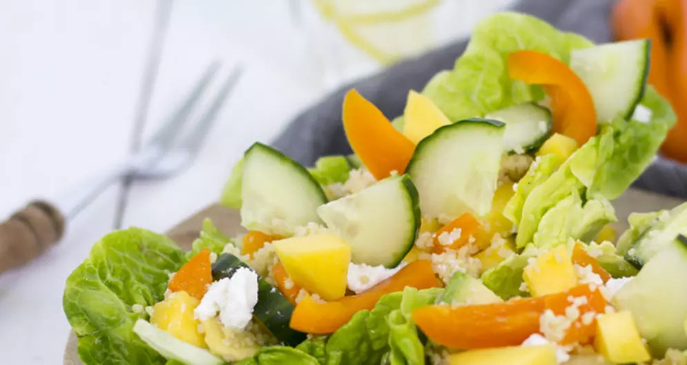 Fresh couscous salad with cucumber, bell pepper, and feta cheese.